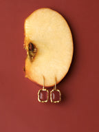 Gold frame earrings with carnelian cabochon and hammered texture — Winding Moonlight