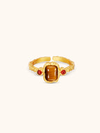 Gold flame ring with tiger's eye cabochon and red agate accents on hammered band — Winding Moonlight