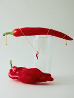Gold chili pepper pendant necklace with red enamel and zircon-set oval — Winding Moonlight