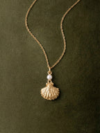 Gold scallop seashell locket necklace opening to reveal a freshwater pearl — Winding Moonlight