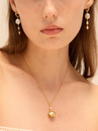 Gold scallop seashell locket necklace opening to reveal a freshwater pearl — Winding Moonlight