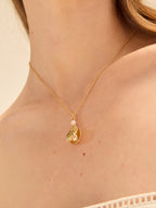 Gold scallop seashell locket necklace opening to reveal a freshwater pearl — Winding Moonlight